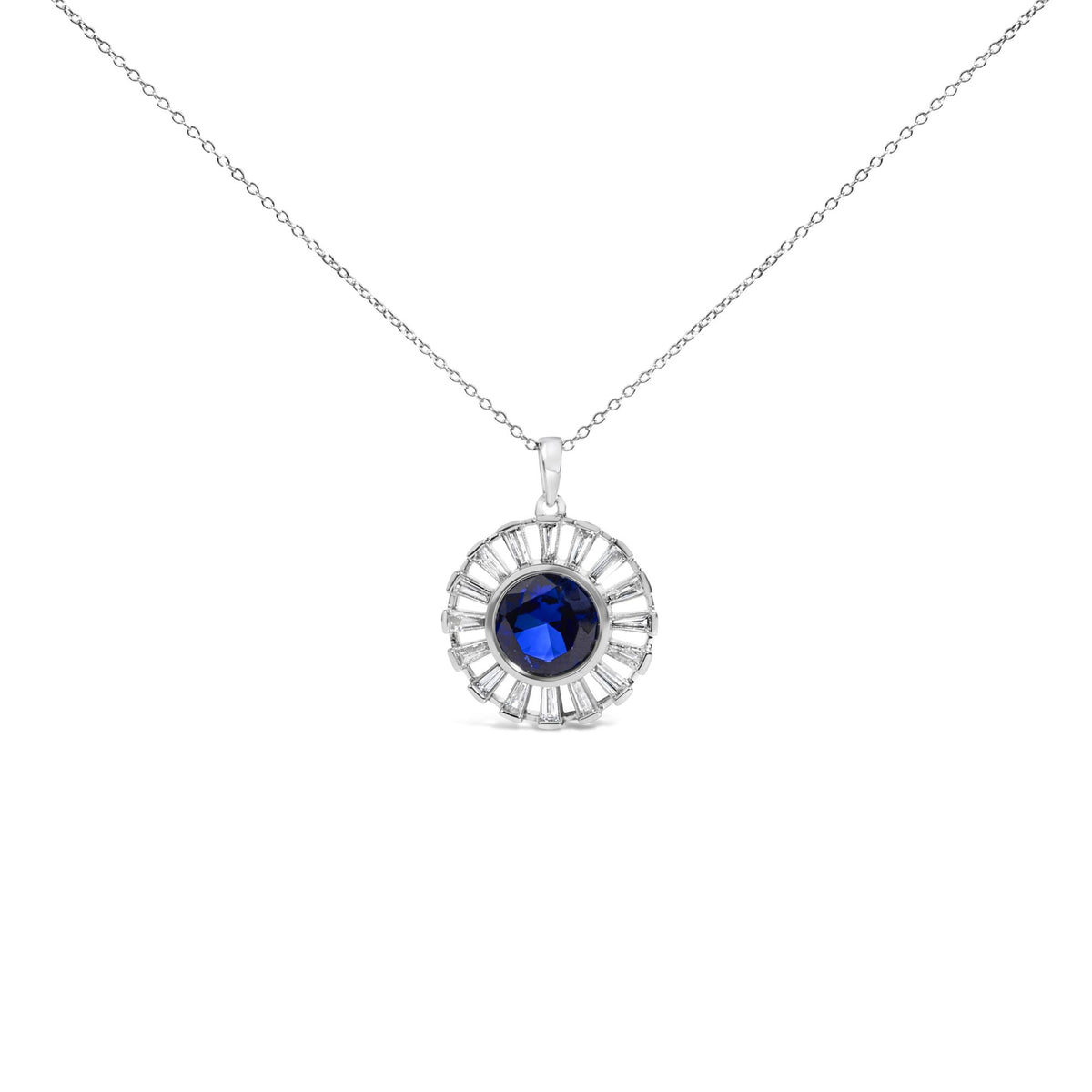 Close-up front view of a white metal necklace pendant featuring a round blue gemstone in the center surrounded by a circular arrangement of white baguette-shaped gemstones in channel settings.