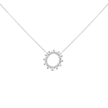 Close-up front view of a white metal necklace with a circular pendant featuring prong-set white round and baguette-shaped gemstones, shown on a white background.