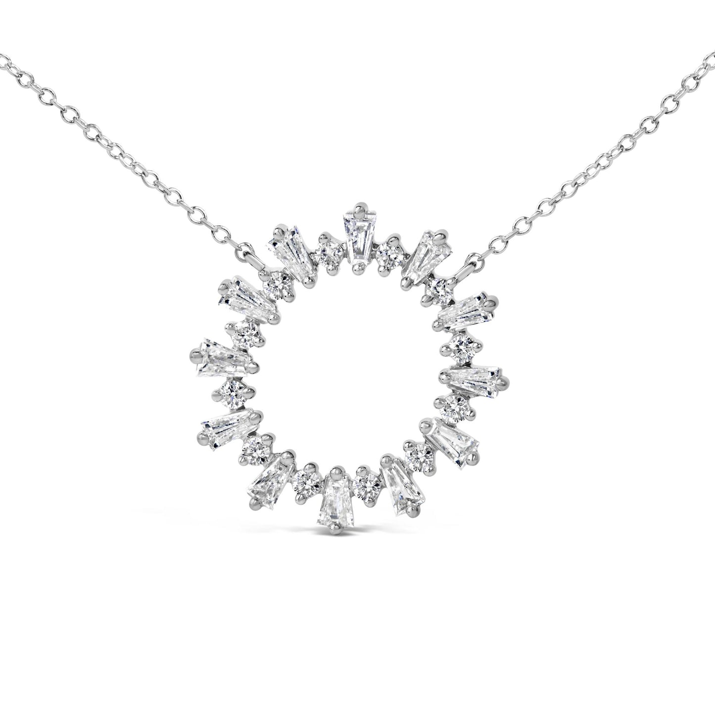 Close-up front angle of a white metal necklace pendant in a circular shape, set with alternating baguette and round white gemstones, shown on a white background.