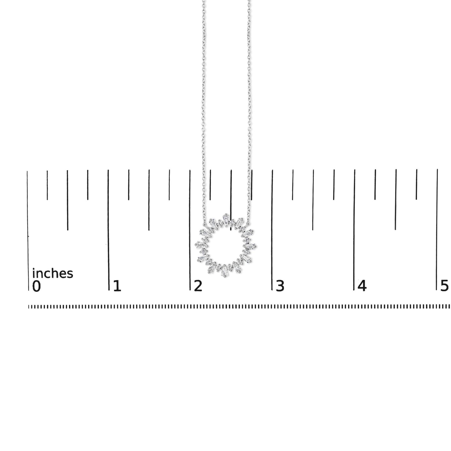 Image showing a white necklace with a circular pendant made of alternating baguette and round white gemstones in prong settings, displayed on a ruler scale, shot from the front angle.