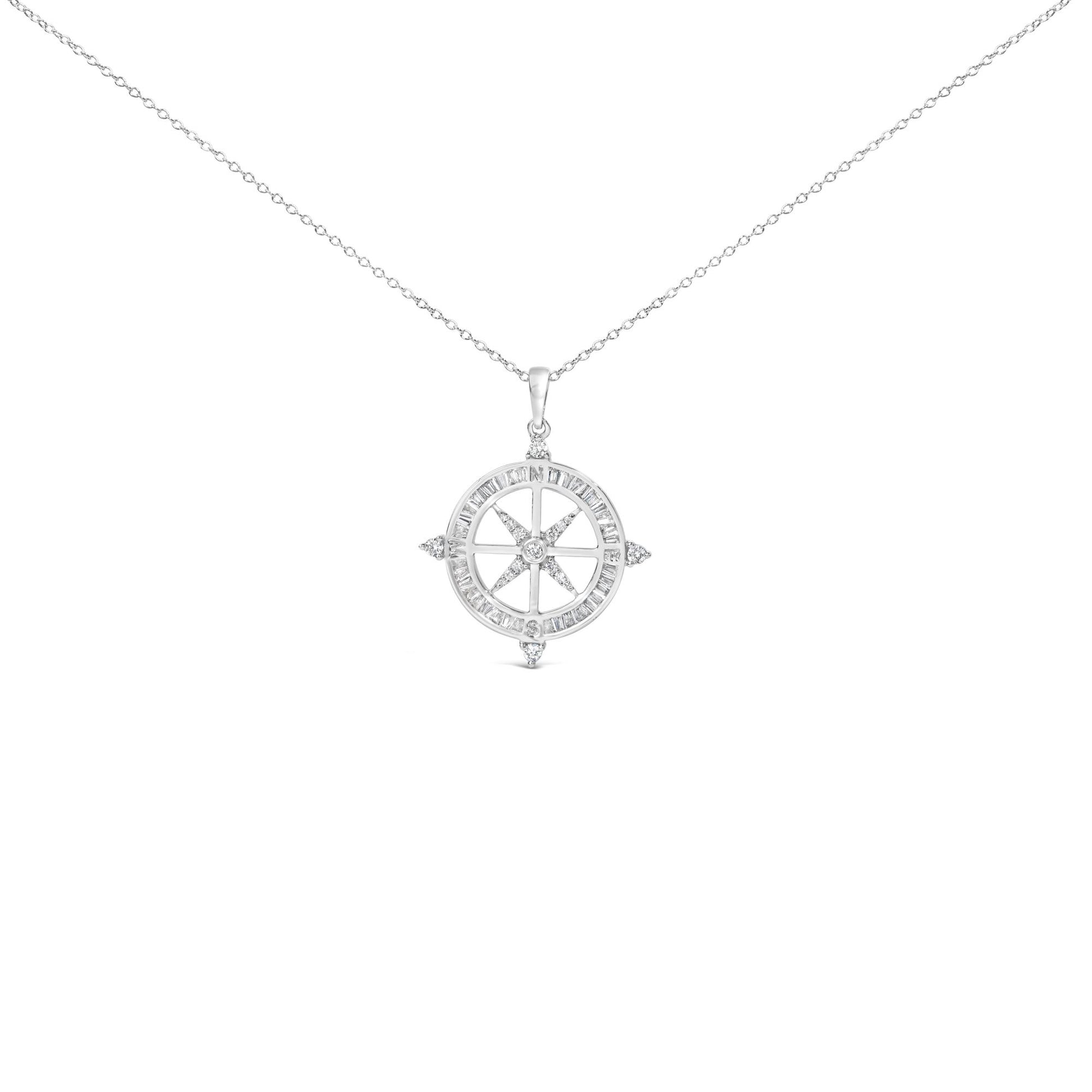 Close-up front view of a white metal necklace with a circular compass pendant featuring white baguette-shaped gemstones in channel settings around the outer edge and white round-shaped gemstones in prong settings forming the compass points.
