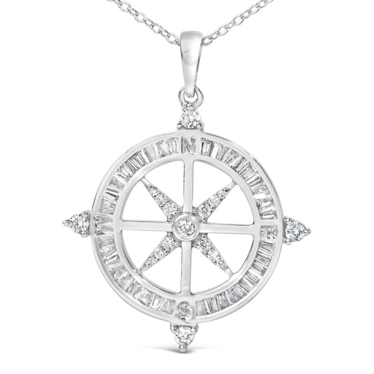 Close-up front view of a white metal compass pendant necklace featuring white baguette-shaped gemstones in a channel setting around the outer circle and white round-shaped gemstones in prong settings at the four cardinal points and center.