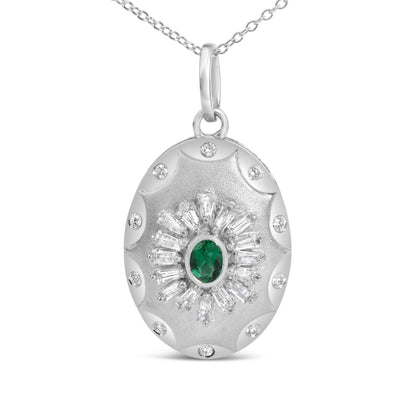 Close-up front view of a white metal oval pendant necklace featuring a central oval green gemstone surrounded by a circle of white baguette-shaped gemstones and smaller round white gemstones around the edge.