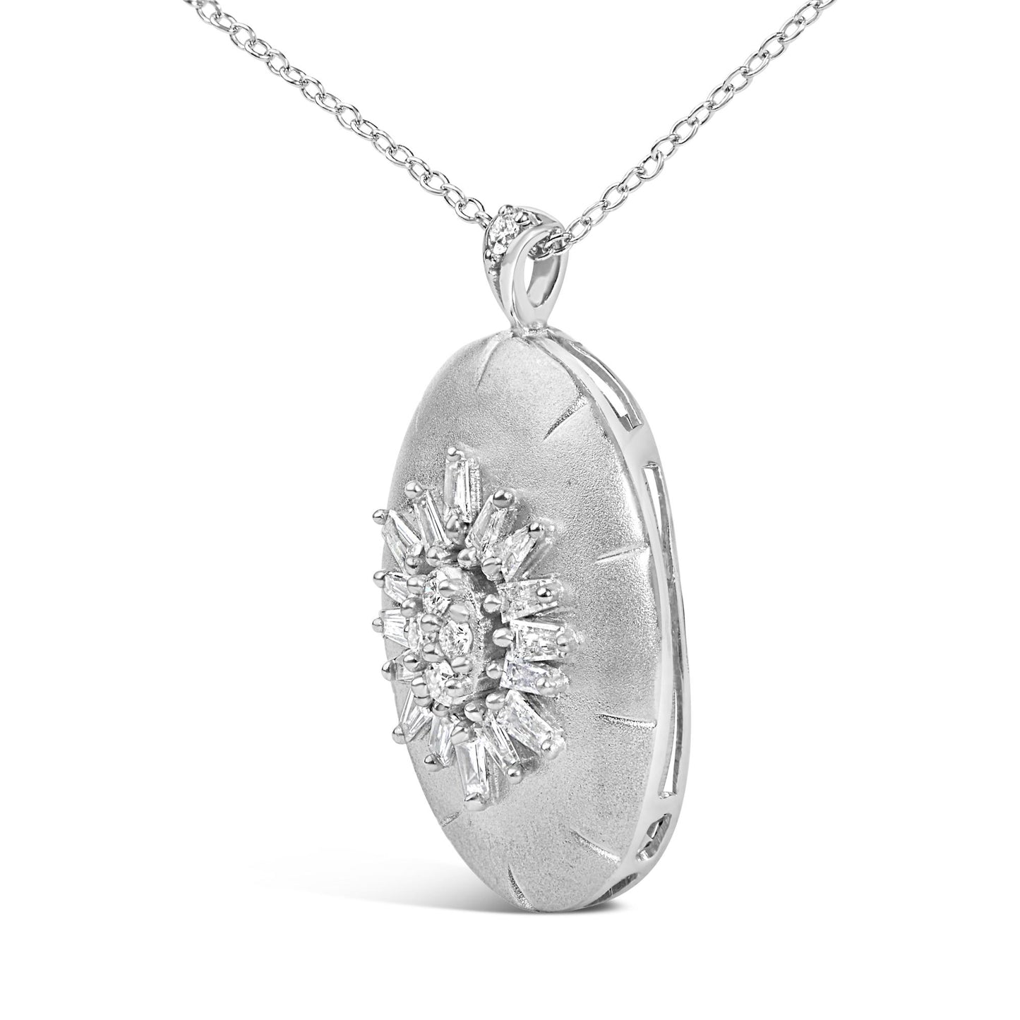 Close-up front angle of a white metal oval pendant necklace with baguette and round white gemstones arranged in a starburst pattern on the pendant surface.