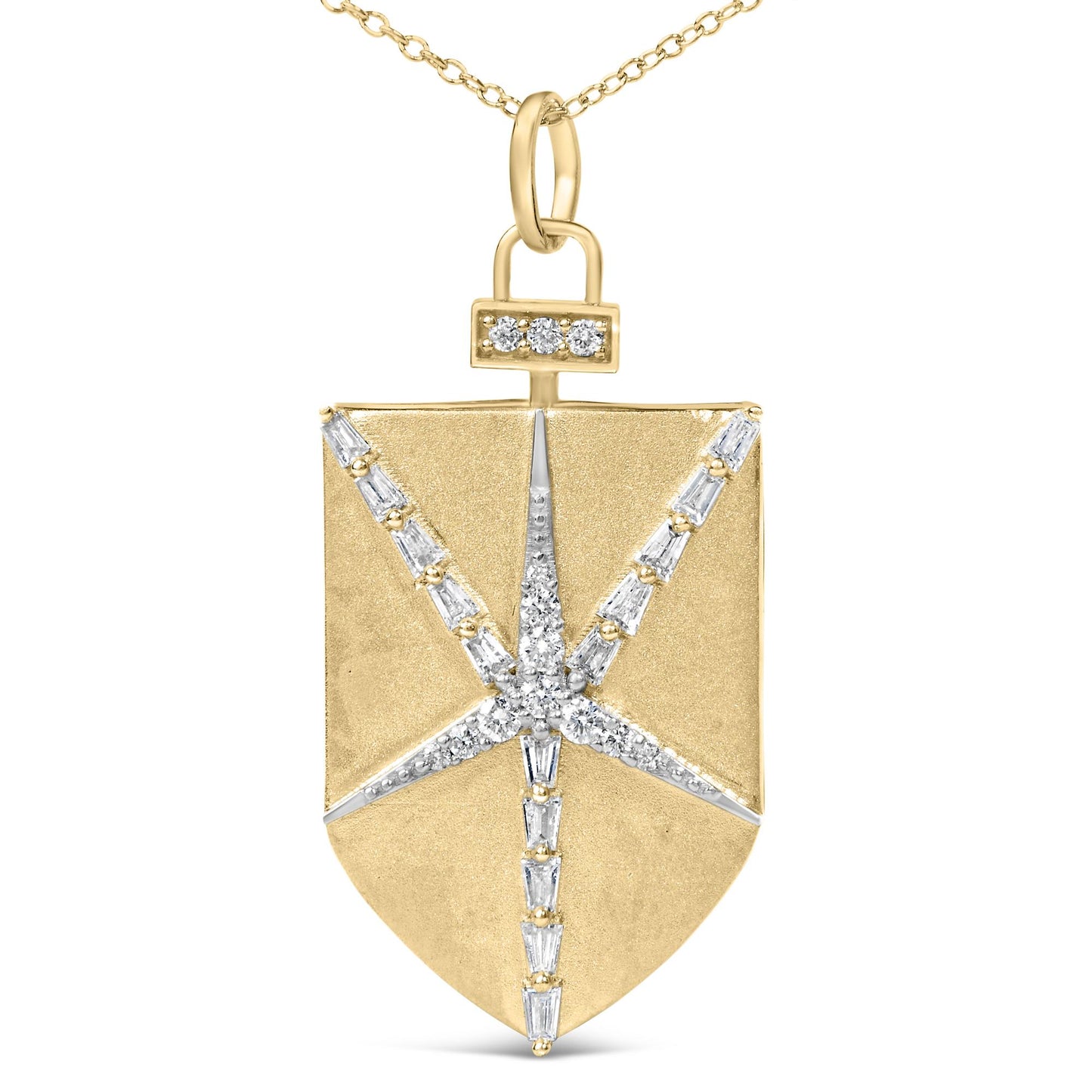 Close-up front view of a yellow metal shield-shaped necklace pendant featuring a starburst pattern of white round and baguette-shaped gemstones in prong settings, shown on a white background.