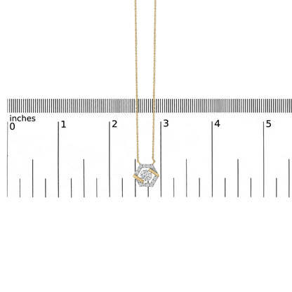 Close-up on a yellow necklace pendant with a hexagonal shape featuring multiple small white gemstones and one central larger white gemstone, shown hanging vertically on a scale.