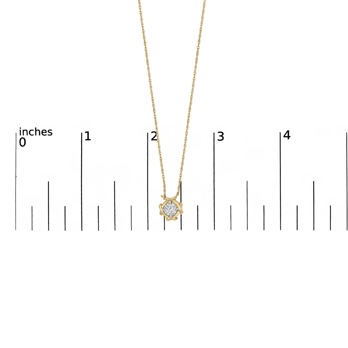 Close-up front view of a yellow metal necklace pendant with a single round white gemstone in a prong setting, shown on a scale.