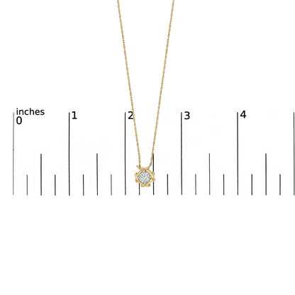 Close-up front view of a yellow metal necklace pendant with a single round white gemstone in a prong setting, shown on a scale.