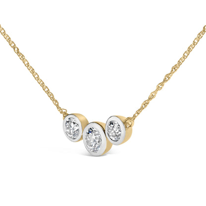 Close-up front angle of a yellow metal necklace featuring a pendant with three round white gemstones in bezel settings.