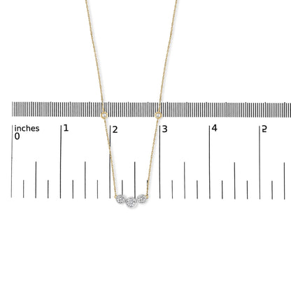 Close-up front view of a yellow necklace with round white gemstones in bezel settings, displayed on a ruler for scale.