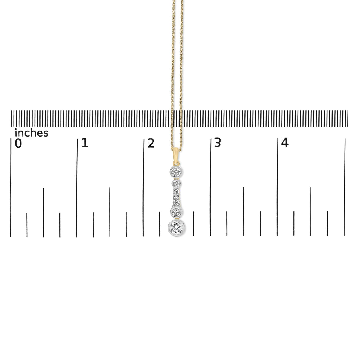 Close-up front view of a yellow metal necklace pendant with multiple round white gemstones in bezel and prong settings, shown on a ruler scale for size reference.