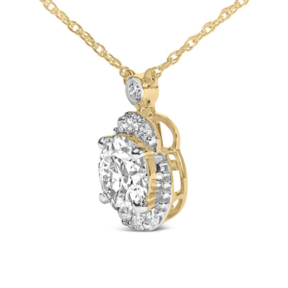 Close-up front angle of a yellow metal necklace featuring an oval pendant with a large clear gemstone center surrounded by smaller white gemstones in prong settings.