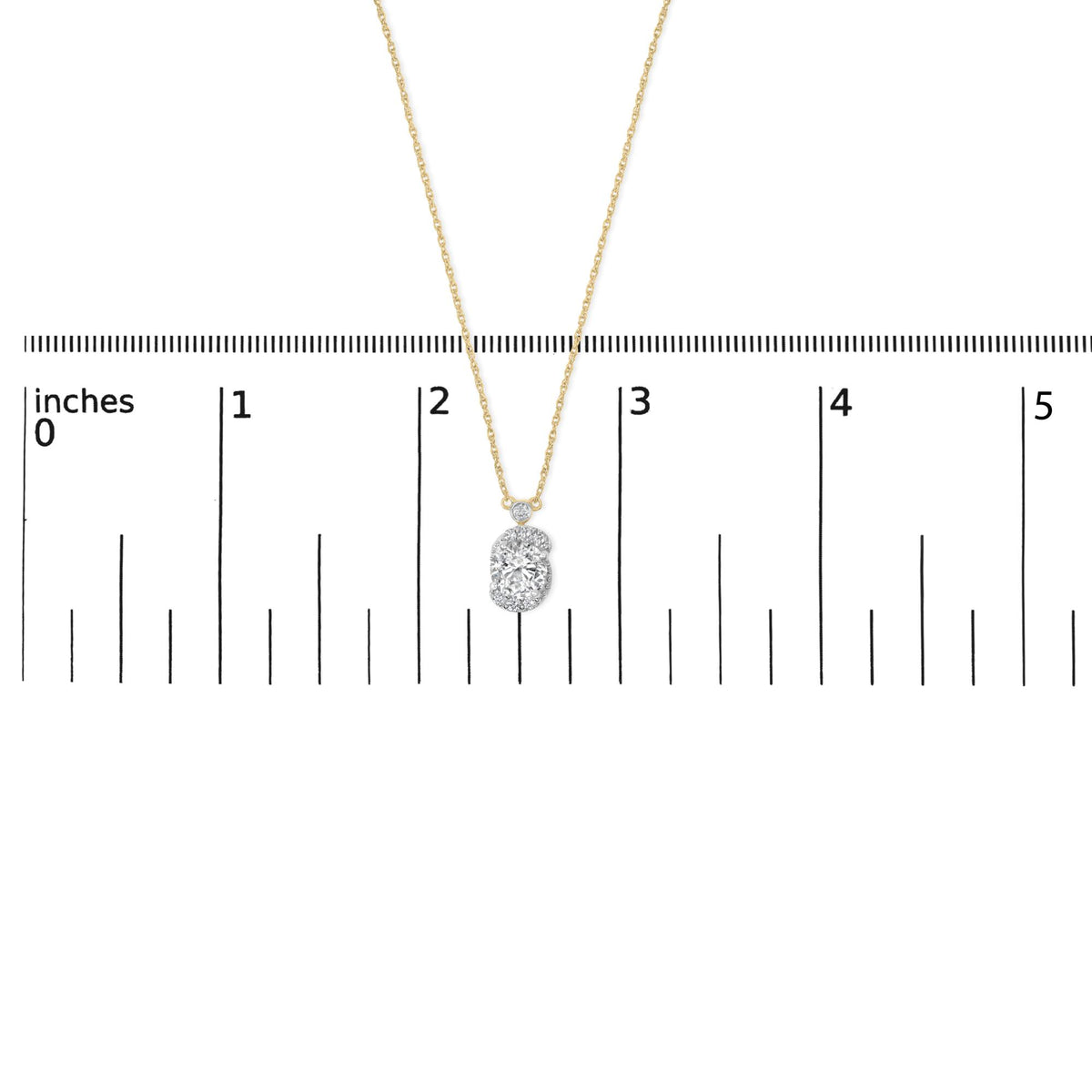 Close-up front view of a yellow metal necklace with a pendant featuring multiple round white gemstones in prong settings, shown on a measurement scale.
