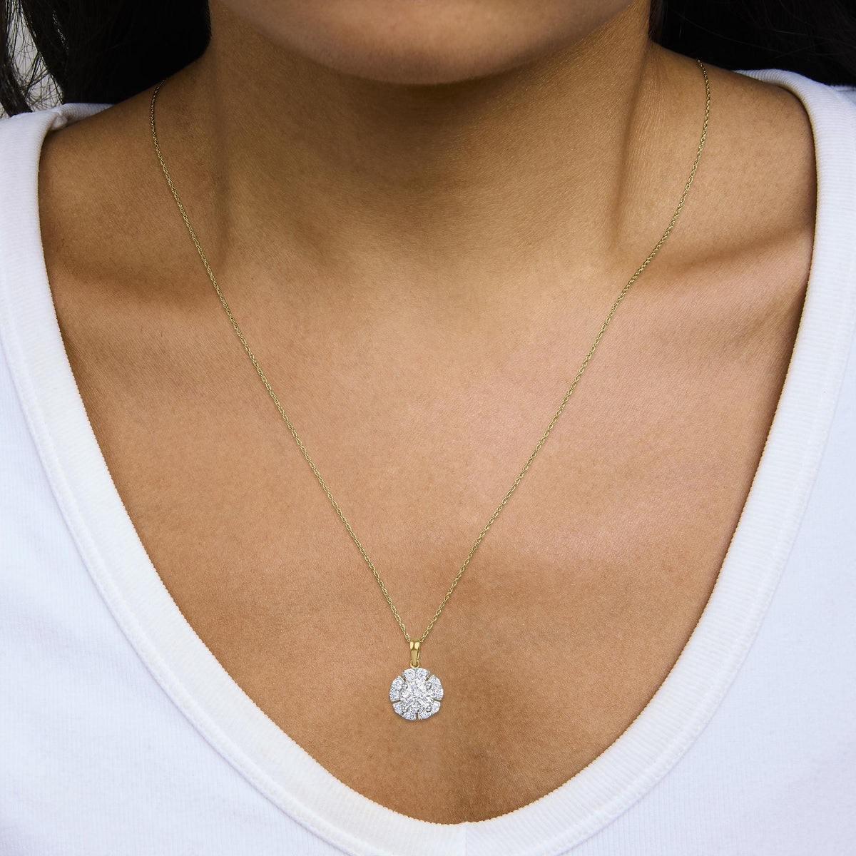 Yellow necklace with a flower-shaped pendant featuring white round gemstones in prong settings, shown worn on a model in a close-up front view.