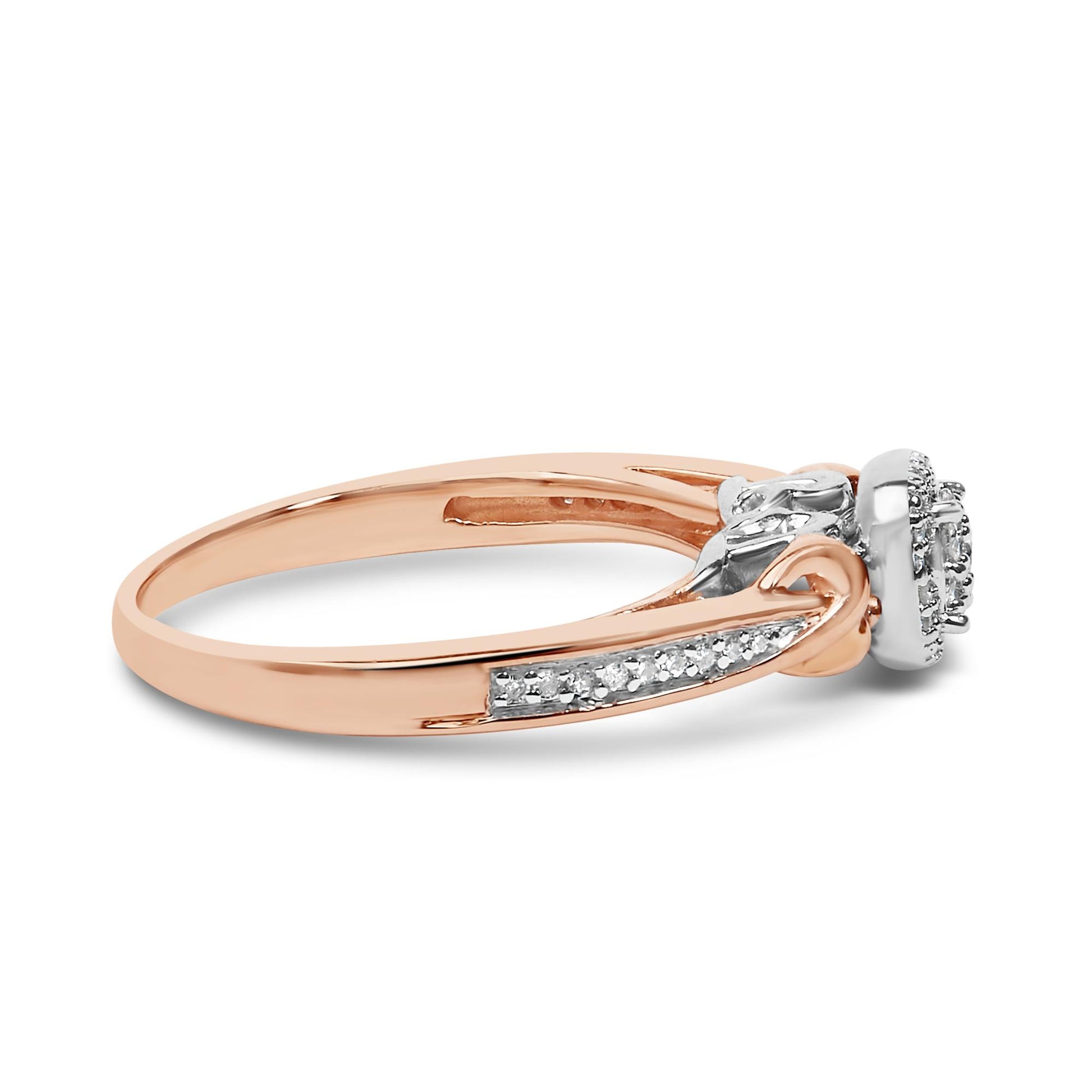 Side angle view of a ring featuring a rose-colored band with a white-colored top setting adorned with round white gemstones in prong settings.