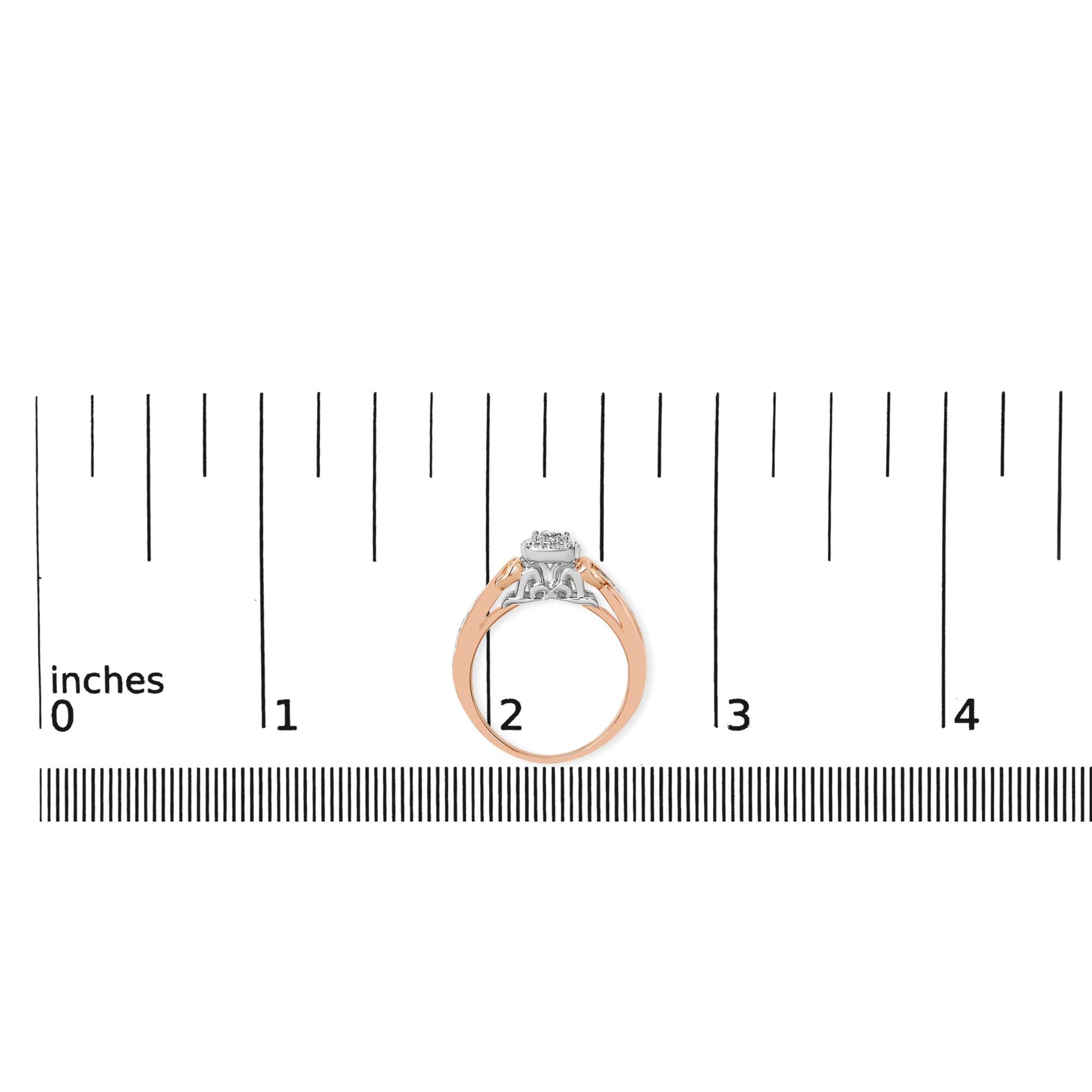 Ring with white and rose metal shown on a ruler scale, side view, featuring round white gemstones in a prong setting on top.