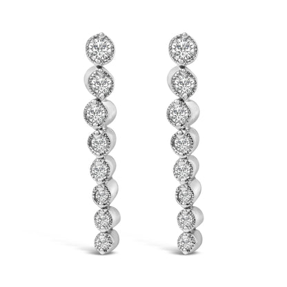 Front view of a pair of white metal earrings, each featuring a vertical row of round white gemstones in prong settings.