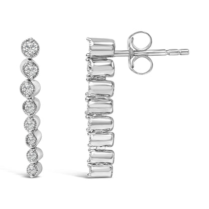 Pair of white metal earrings with a vertical row of round white gemstones in prong settings, shown in front and side views on a white background.