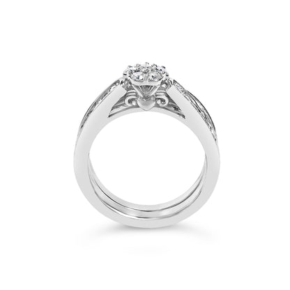 Front angle view of a white metal ring with a cluster of round white gemstones in prong settings on top and additional gemstones along the upper side bands.
