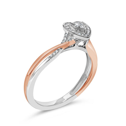 Ring with white and rose metal colors shown at an angled close-up view, featuring a pear-shaped cluster of round white gemstones in prong settings atop the band.