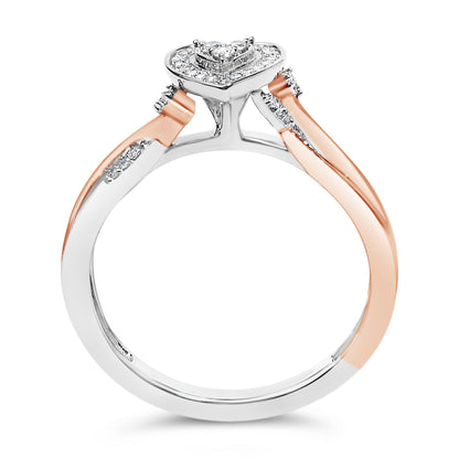 Close-up front angle of a white and rose metal ring featuring a heart-shaped top adorned with round white gemstones in prong settings.