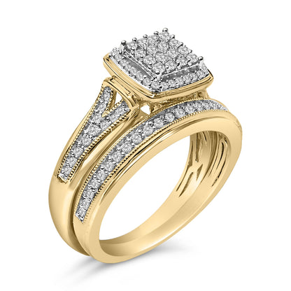 Close-up angled view of a yellow and white metal ring featuring a square cluster of white round gemstones in prong settings and rows of white round gemstones along the split shank.