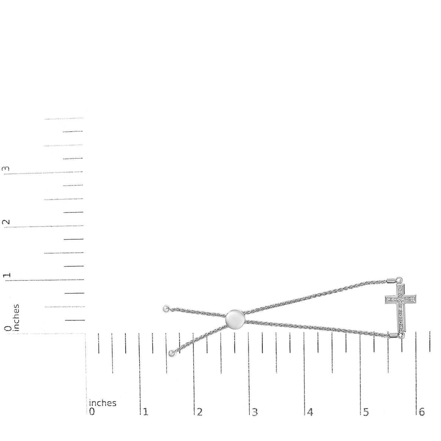 White metal bracelet with a cross pendant set with white round gemstones in pave setting, shown flat on a measuring scale, top-down angle.