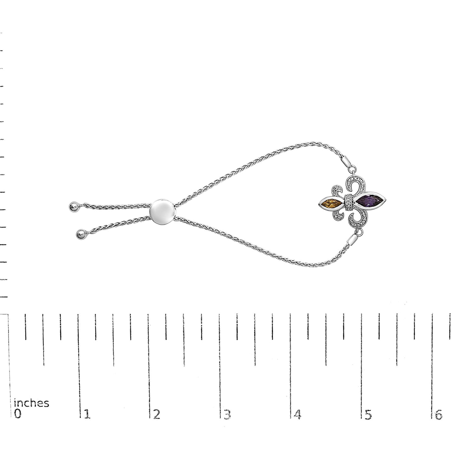 White bracelet with a fleur-de-lis design featuring a purple marquise-shaped gemstone, an orange marquise-shaped gemstone, and multiple small round white gemstones in a pave setting, displayed on a ruler for size reference, shot from above.