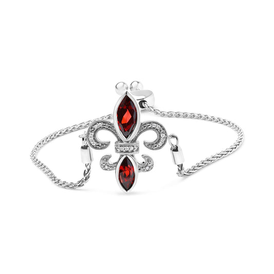White metal bracelet with a fleur-de-lis centerpiece featuring two marquise-shaped red gemstones and round white gemstones in prong settings, shown from a front angle on a white background.
