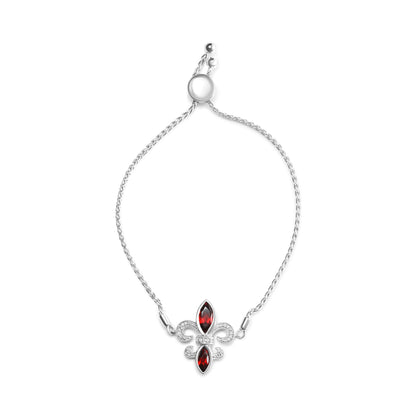Bracelet with a white metal braided chain and a fleur-de-lis shaped centerpiece featuring two red marquise-shaped gemstones and multiple small round white gemstones, shown from a top-down angle on a white background.