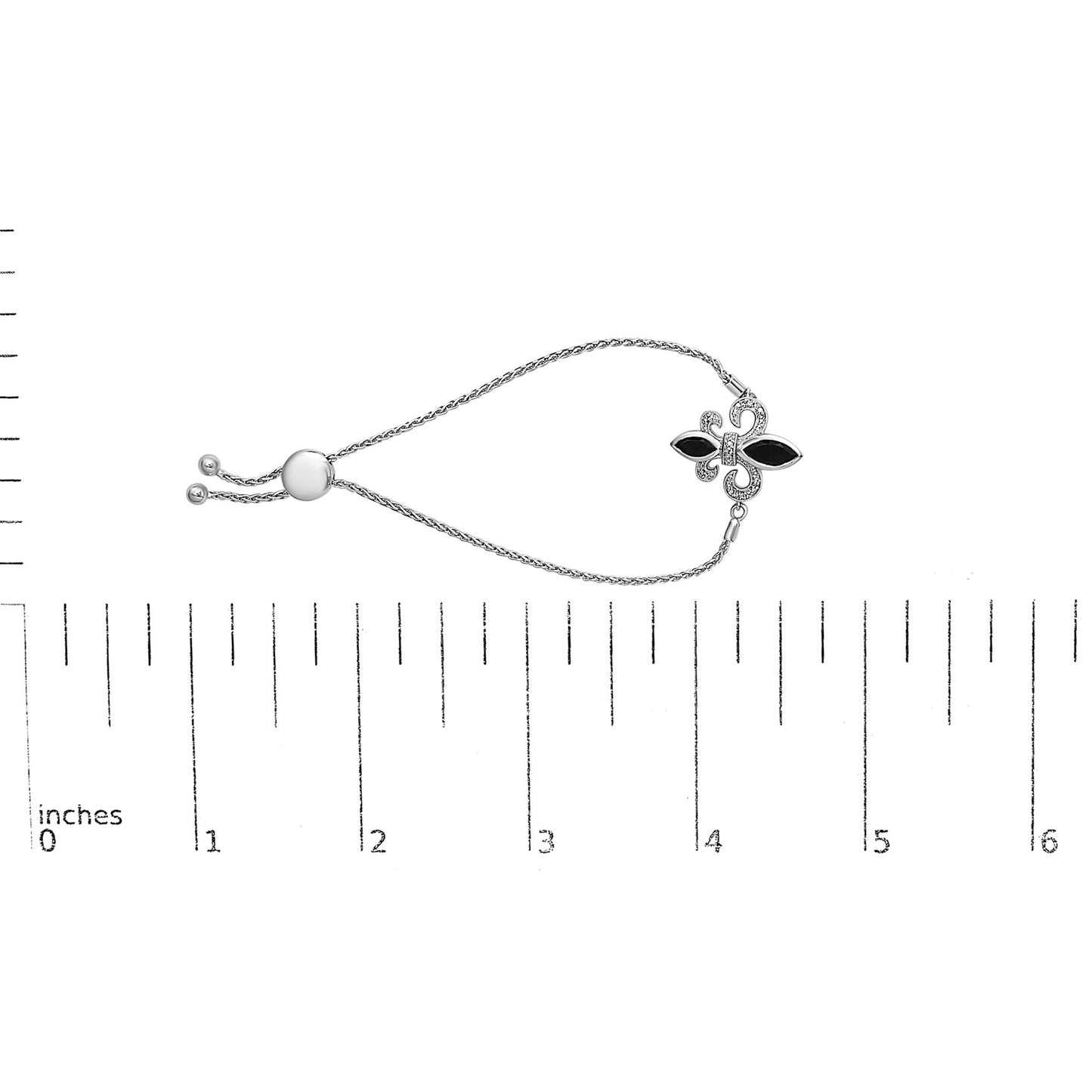 White metal bracelet with two black marquise-shaped gemstones and small white round gemstones in pave setting, shown on a ruler for size reference, top down view.