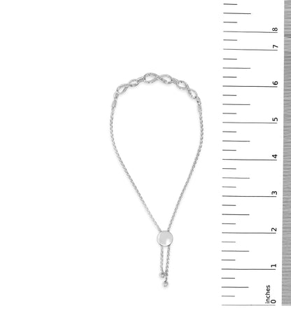 White bracelet with a round, pave-set white gemstones detail, shown on a scale, front view.