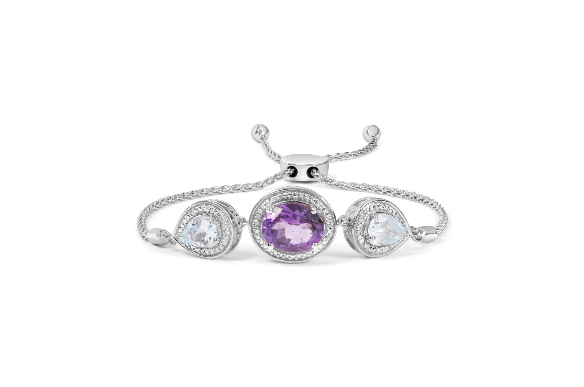 White metal bracelet with a center oval purple gemstone and two pear-shaped blue gemstones on each side, all surrounded by small round white gemstones, shown from the front angle.