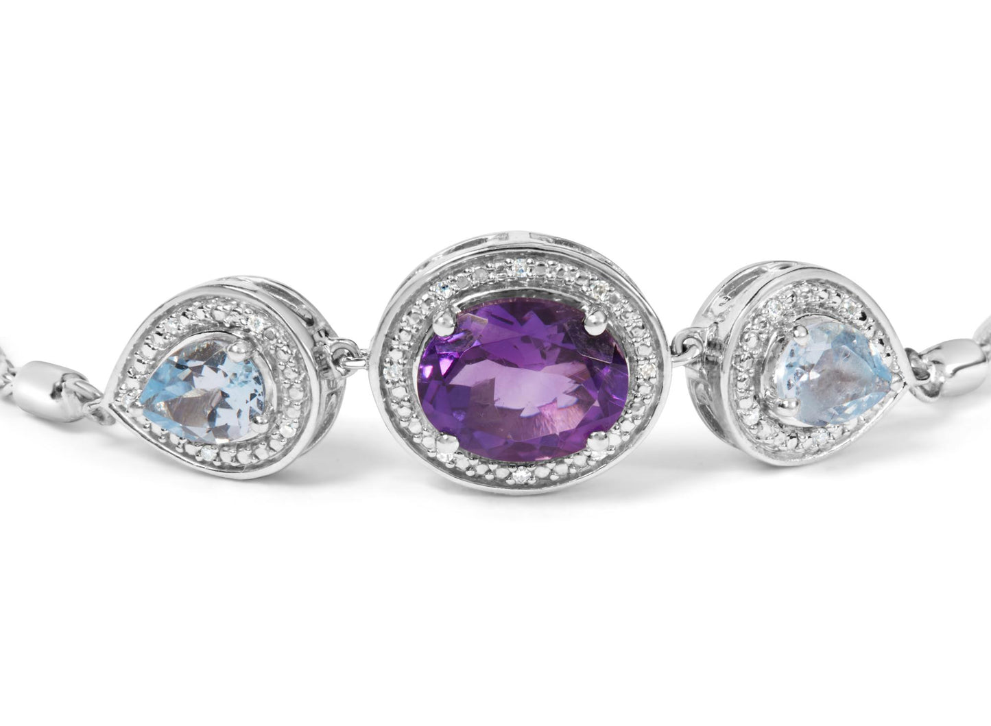 Close-up front angle of a white metal bracelet featuring a central oval purple gemstone surrounded by small round white gemstones, flanked on each side by pear-shaped blue gemstones also bordered with small round white gemstones.