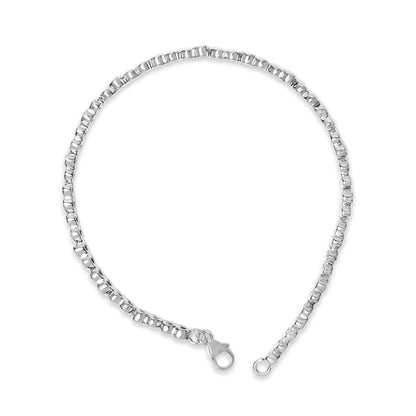 Close-up top view of a white metal bracelet with round white gemstones in pave setting, showing the clasp ends.