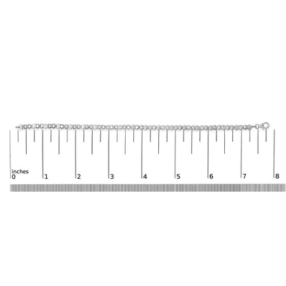 White bracelet with alternating smooth and pave-set heart-shaped links featuring white gemstones, shown laid flat on a ruler scale, shot from above.
