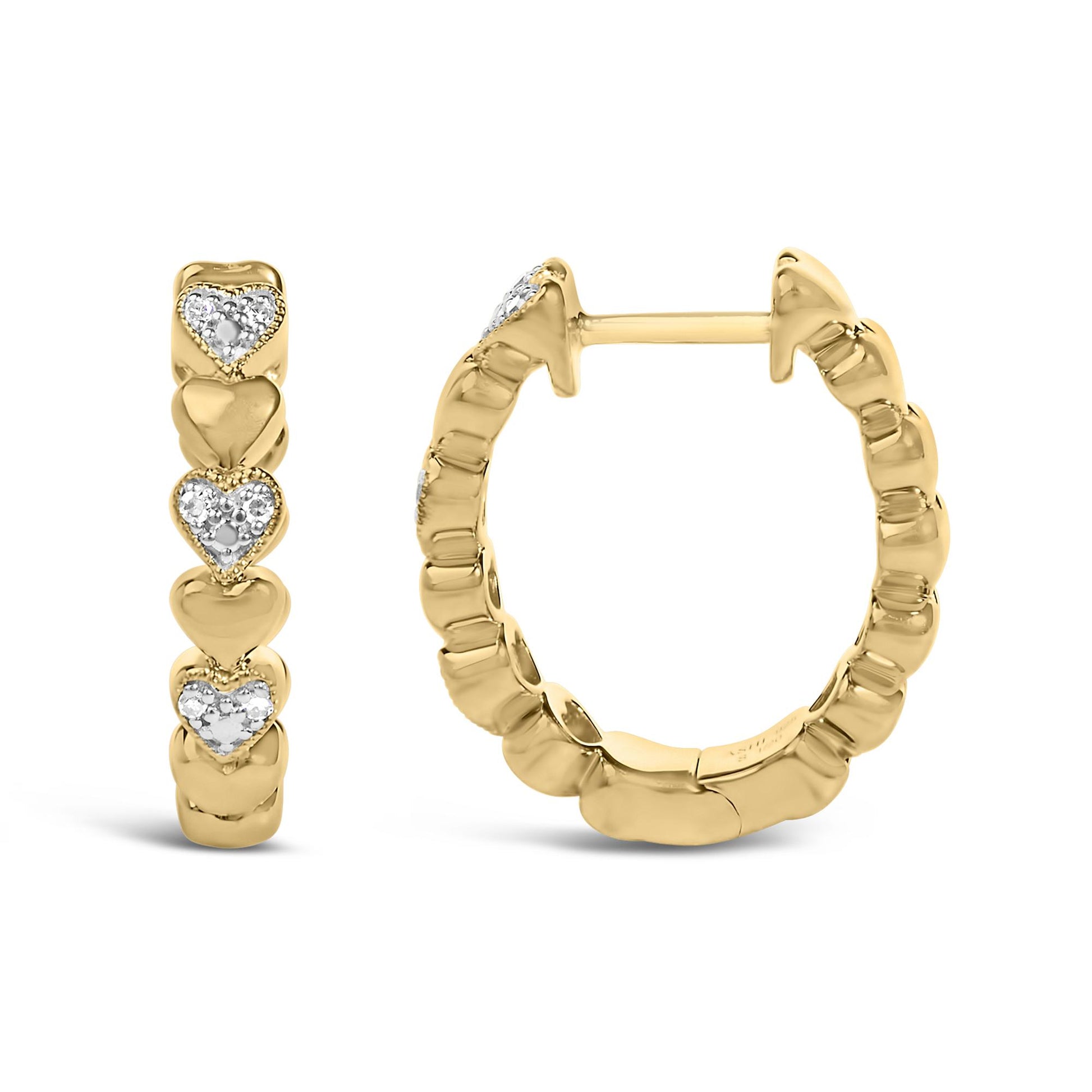 Close-up front and side view of a pair of yellow metal hoop earrings with heart shapes accented by white round gemstones in a pave setting, shown on a white background.