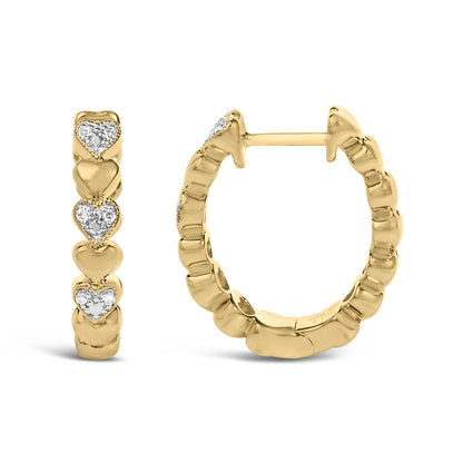 Close-up front and side view of a pair of yellow metal hoop earrings with heart shapes accented by white round gemstones in a pave setting, shown on a white background.
