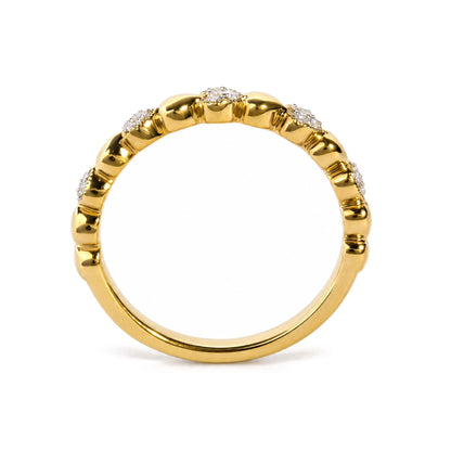 Yellow ring with raised sections, each set with clusters of round white gemstones in pave setting, shown in a front-facing close-up view.