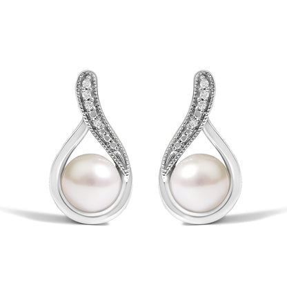 Close-up front view of a pair of white metal earrings featuring a white gemstone at the bottom and a curved section adorned with small round white gemstones in a pave setting.