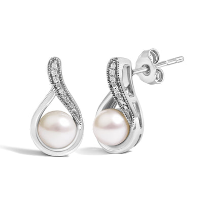 Close-up front view of white metal earrings with a curved design. Each earring features a large round white gemstone at the bottom center and a row of small round white gemstones in a pave setting along the curve. The earrings have post backings visible from the side.