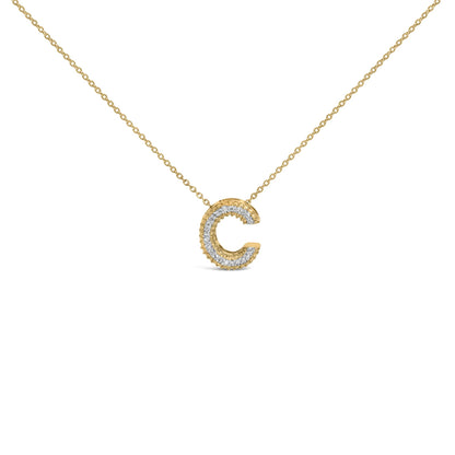 Close-up front view of a yellow metal necklace with a pendant shaped as the letter 'C' adorned with white round gemstones in a prong setting.