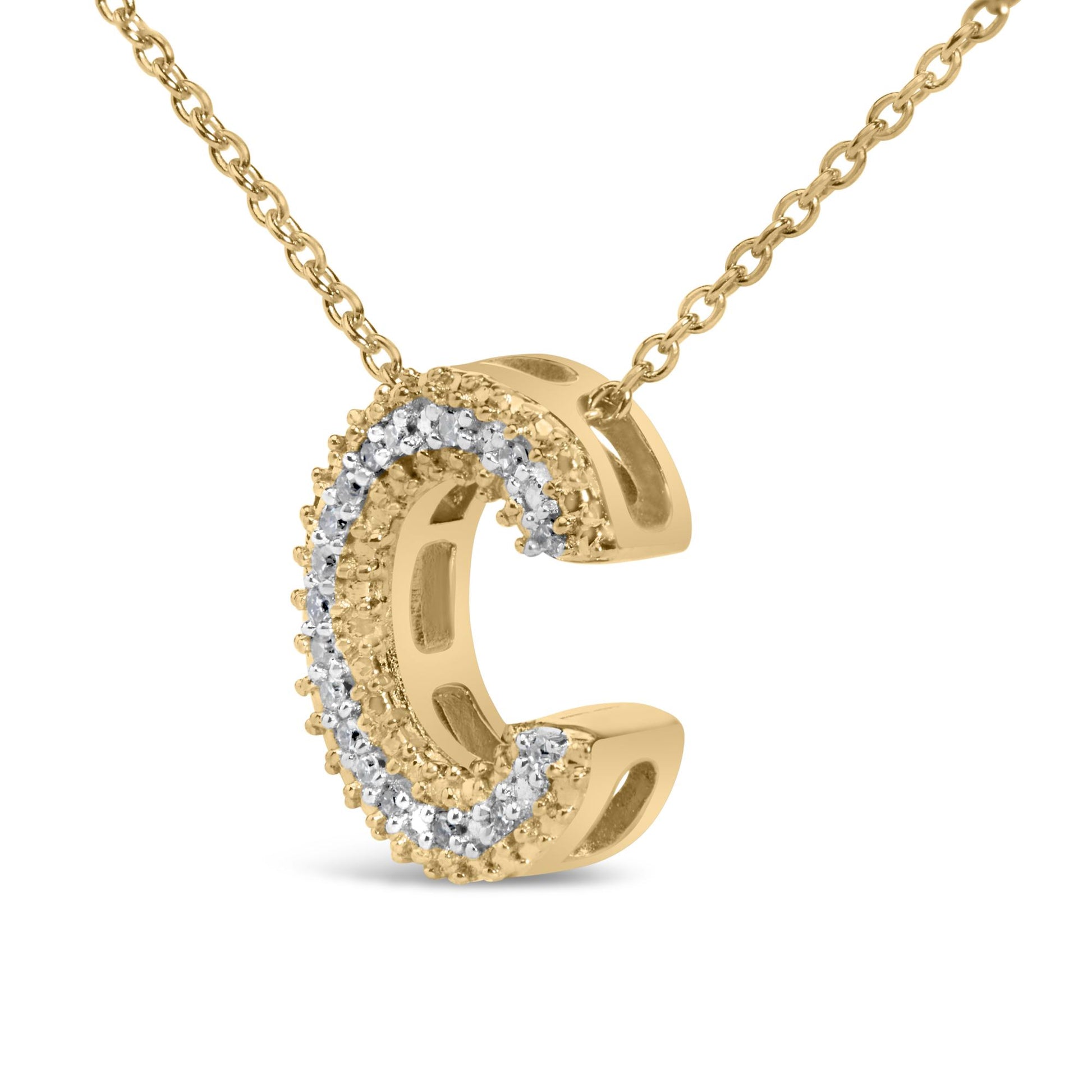 Close-up front angle of a yellow metal necklace pendant in a curved shape, adorned with round white gemstones set in prongs along the outer edge, shown on a white background.