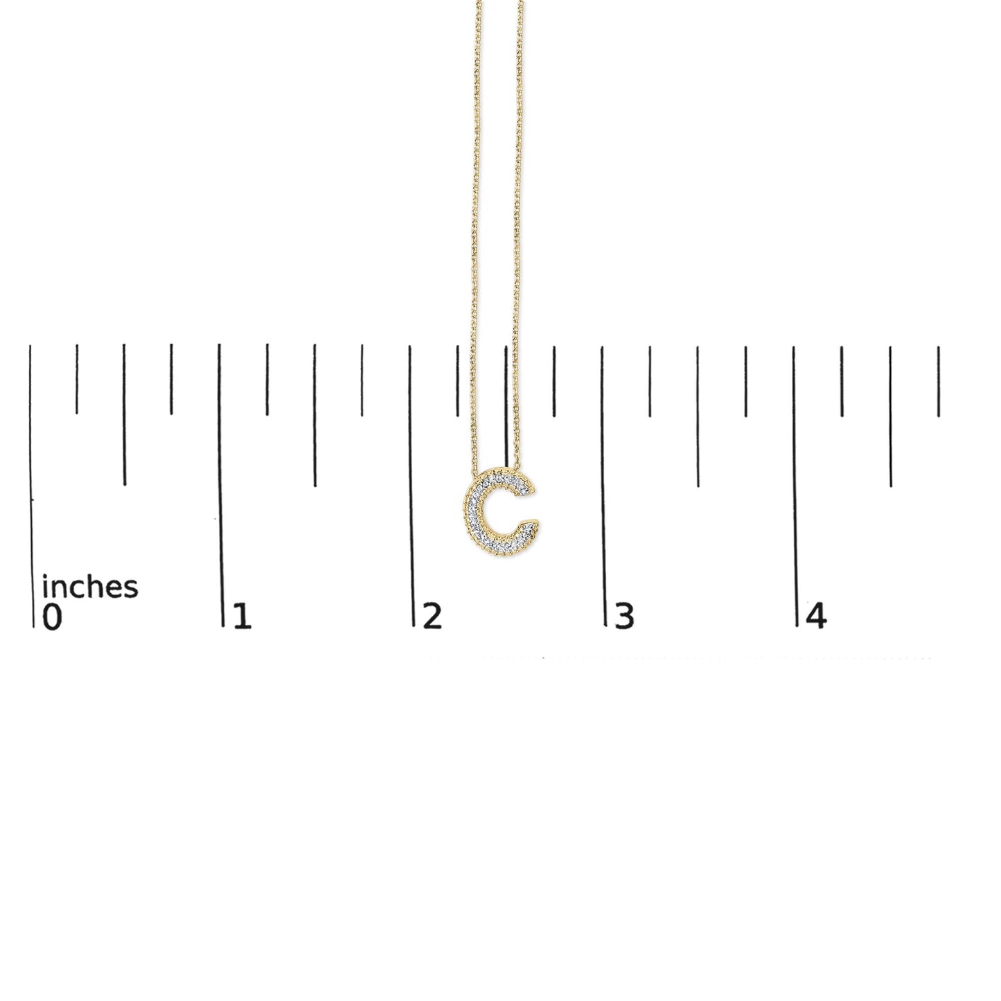 Yellow necklace with a pendant shaped like the letter C, outlined with white gemstones in prong settings, shown on a scale with an overhead angle.