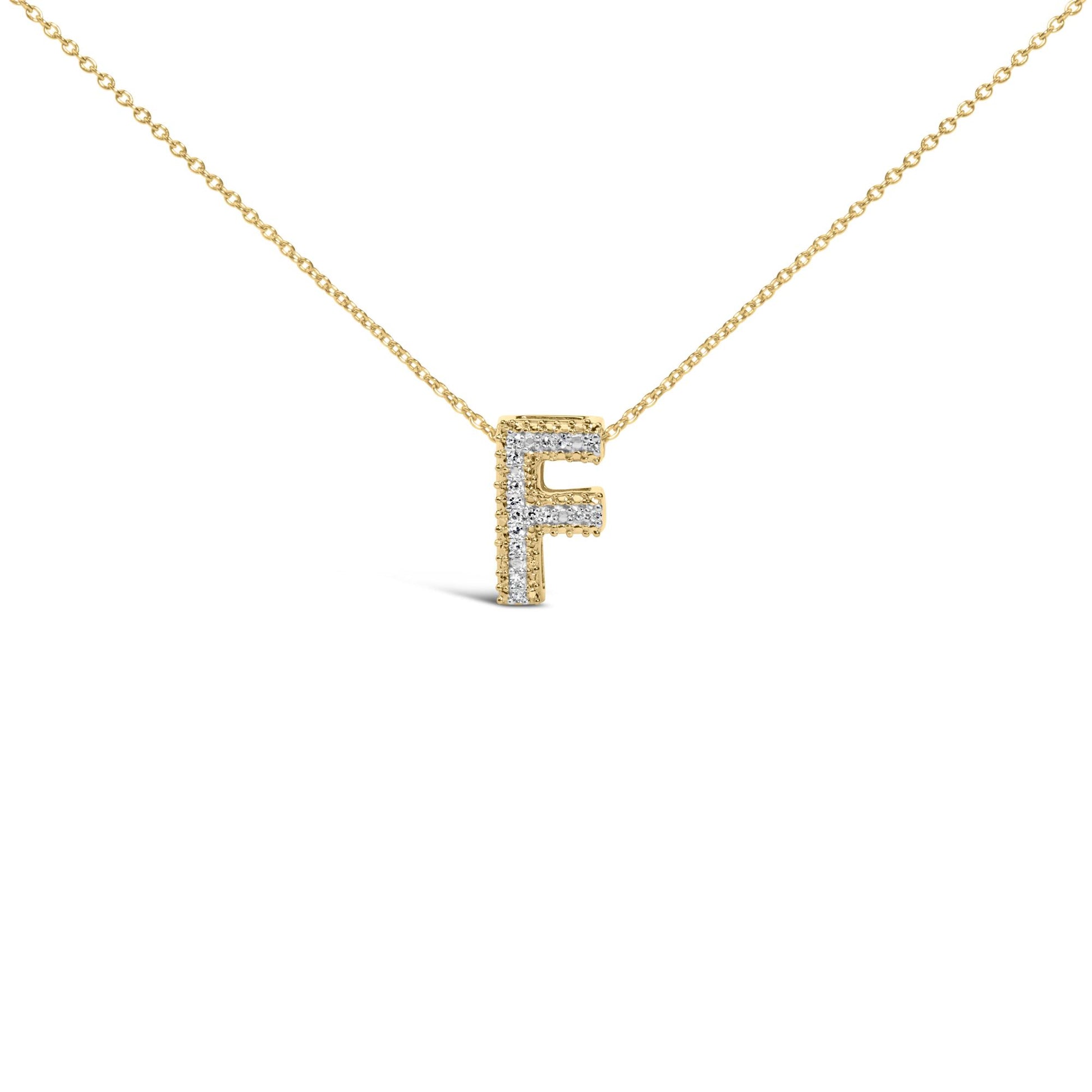 Close-up front view of a yellow metal necklace with a pendant in the shape of the letter 'F' adorned with white gemstones set in prongs, shown on a white background.