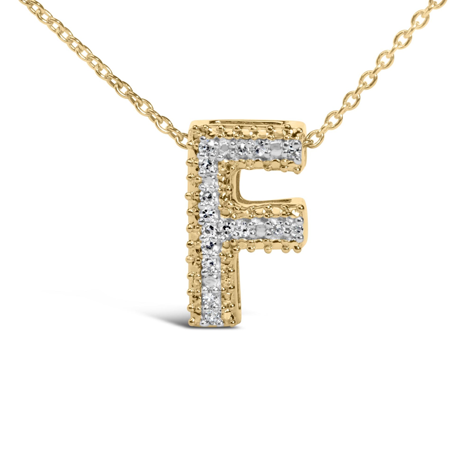 Close-up front angle of a yellow metal necklace pendant in the shape of the letter 'F' adorned with prong-set white gemstones, shown on a white background.