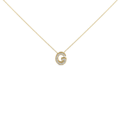 Close-up front view of a yellow metal necklace with a pendant shaped like the letter 'G,' embellished with round white gemstones in prong settings along its outline.
