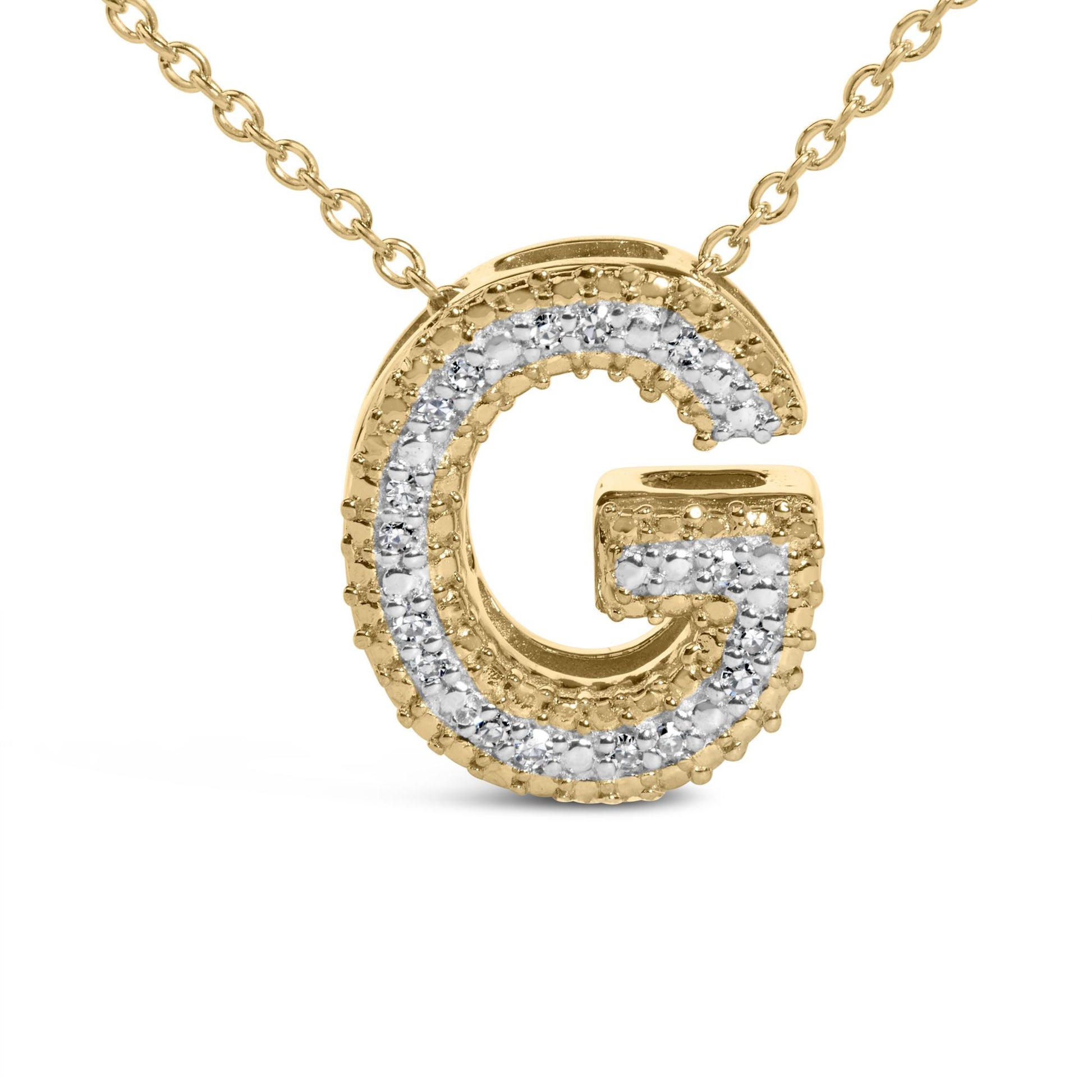 Close-up front view of a yellow metal necklace pendant shaped like the letter G, featuring a row of white gemstones in a prong setting along its edges.