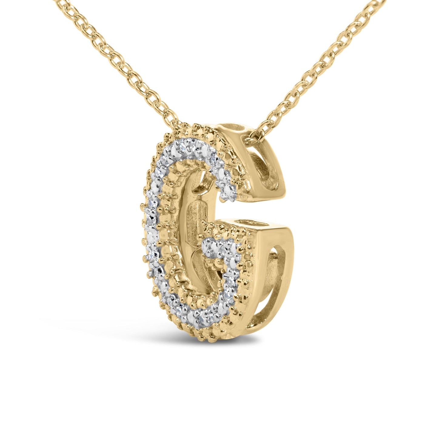 Close-up front angle of a yellow metal necklace pendant in the shape of the letter G, adorned with white round prong-set gemstones along the front surface, shown on a white background.