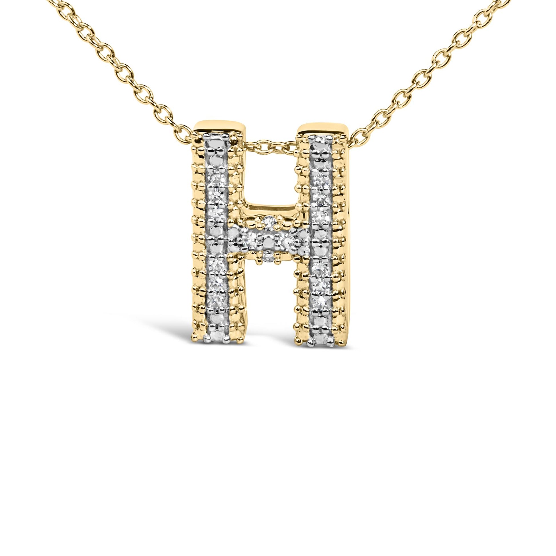 Close-up front view of a yellow necklace pendant in the shape of the letter 'H' adorned with white round gemstones in prong settings along its lines.